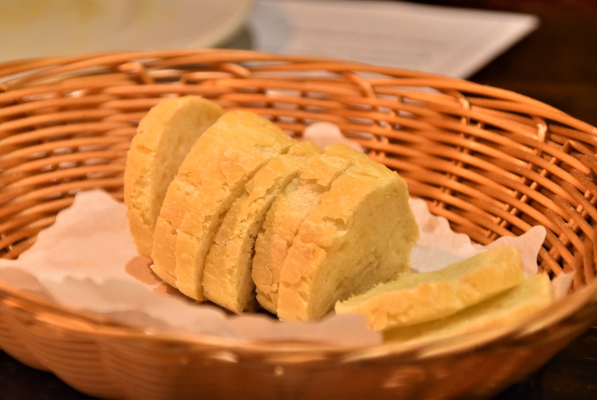 sliced french bread on brown woven basket